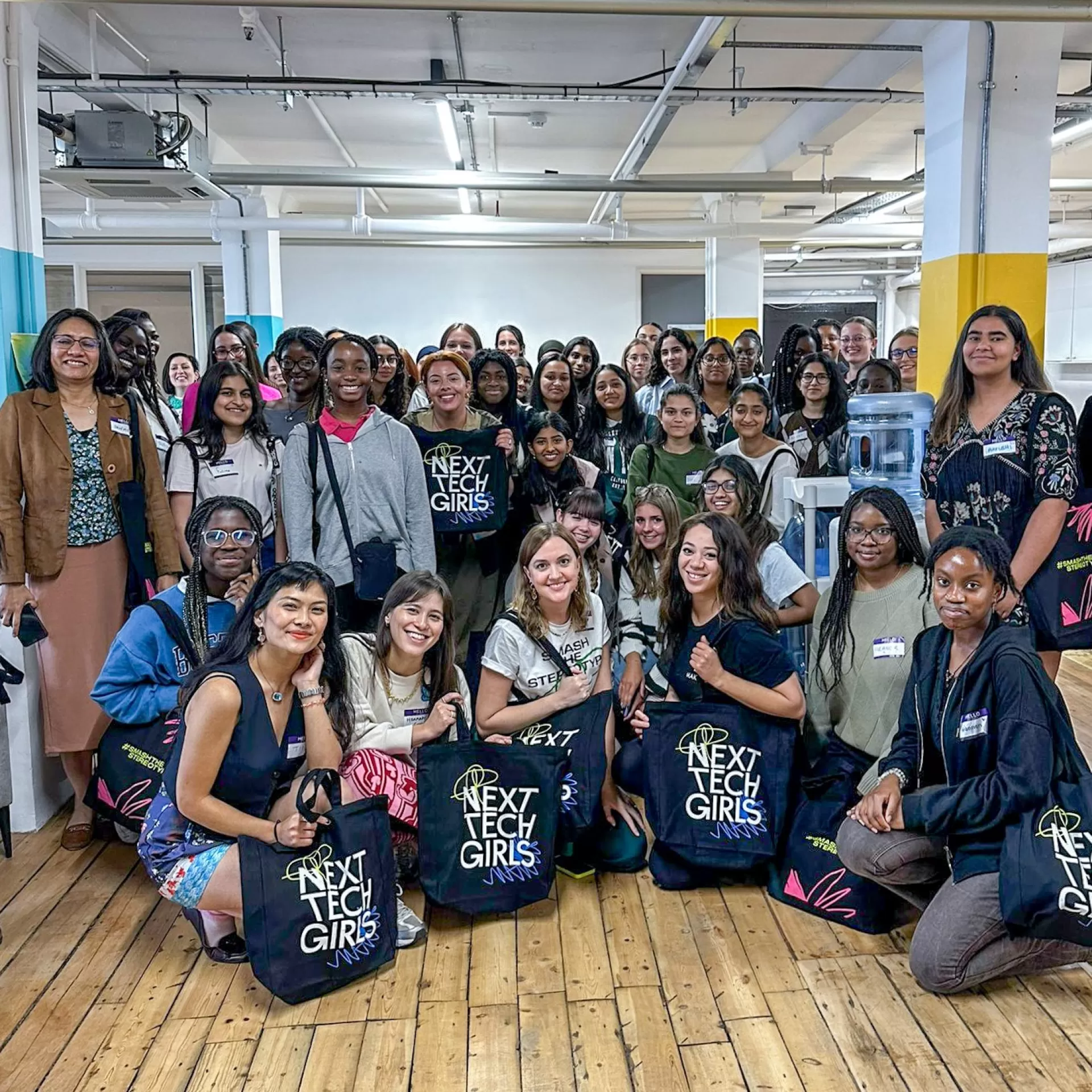 All the attendees of next tech fest, pictured together, smiling.